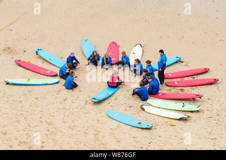 Una lezione di surf sulla Spiaggia Great Western in Newquay in Cornovaglia. Foto Stock