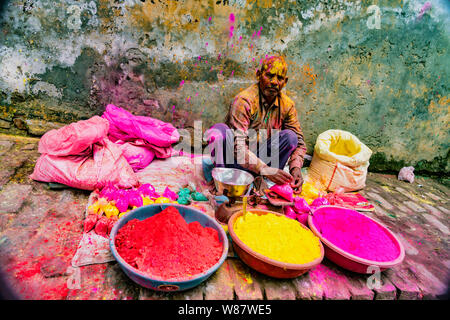 Barsana, India - 23 Febbraio 2018 - Un uomo vende la polvere di vernice per essere gettato da buontemponi durante Holi festival Foto Stock