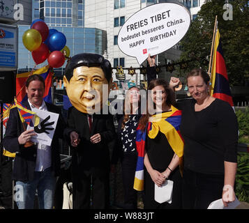 Berlino, Germania. 08 Ago, 2019. I partecipanti prendono parte a un rally dell'associazione "Tibet Initiative Deutschland e.V." con segni, bandiere, palloncini e una maschera del presidente cinese Jinping di fronte all'ambasciata cinese. Sul suo trentesimo compleanno, il club commemora l'occupazione del Tibet da parte della Cina dal 1950. Credito: Taylan Gökalp/dpa/Alamy Live News Foto Stock