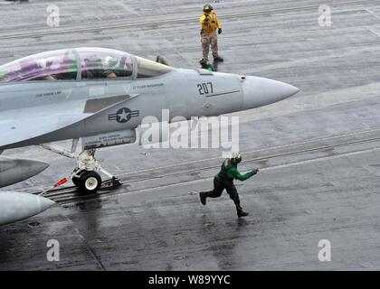 Un F/A-18F Super Hornet aeromobile assegnati a Strike Fighter Squadron 211 si prepara al lancio dalla catapulta tre ciclico durante le operazioni di volo a bordo della portaerei USS Enterprise (CVN 65). L'Enterprise e Carrier aria Wing 1 sono sulla distribuzione di routine di condurre le operazioni di sicurezza marittima NEGLI STATI UNITI Quinta Flotta area di responsabilità. Foto Stock