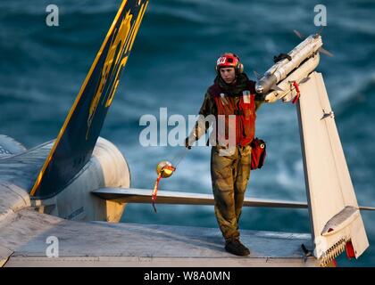 Un U.S. Navy sailor rimuove il cappuccio da una fine-9 missile attaccato a un F/A-18C Hornet aeromobile a bordo della portaerei USS John C. Stennis (CVN 74) nel Golfo Arabico su dicembre 3, 2011. John C. Stennis è distribuito negli Stati Uniti Quinta Flotta area di responsabilità condurre le operazioni di sicurezza marittima e le missioni di sostegno come parte delle operazioni Enduring Freedom e nuova alba. Foto Stock