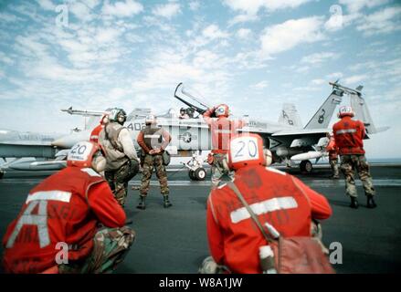 Ponte di volo equipaggio assegnati a Strike Fighter Squadron 86 preparare un F/A-18C Hornet per lanciare sul ponte di volo della portaerei USS George Washington (CVN 73) come la nave cuoce a vapore nel Golfo Persico nel febbraio 21, 1998. La Washington e la sua avviato Carrier aria Wing 1 è operativo nel Golfo Persico a sostegno del funzionamento orologio meridionale che sono gli Stati Uniti e le forze della coalizione esecuzione della no-fly zone su Iraq meridionale. La Hornet è da Strike Fighter Squadron 86, Naval Air Station Cecil Campo, Fla. Foto Stock