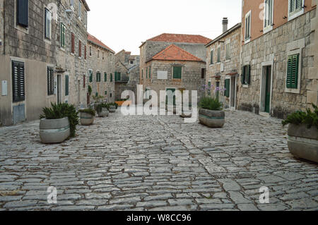 Typicall dalmata architettura in pietra, le strade della città Postira, isola di Brac, Croazia Foto Stock