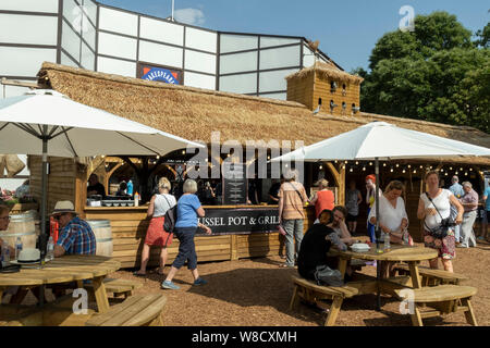 Persone al di fuori del Rose Theatre di Shakespeare bar e bancarelle alimentari del villaggio York North Yorkshire Inghilterra Regno Unito GB Gran Bretagna Foto Stock