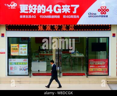 --FILE--A passeggiate a piedi passato un ramo di China Unicom in Yichang city, centrale cinese della provincia di Hubei, 23 aprile 2015. China Unicom (Hong Kong) C Foto Stock