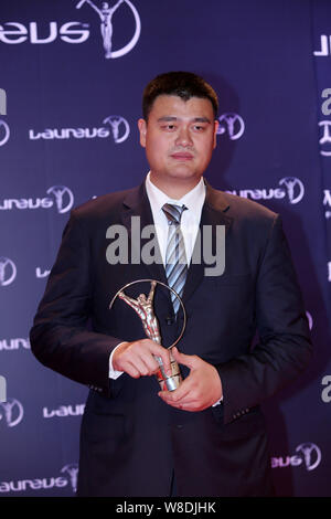 --FILE--pensionato cinese di pallacanestro Yao Ming pone con il suo trofeo di spirito sportivo Award dopo la cerimonia di premiazione per il Laureus World Sports Foto Stock