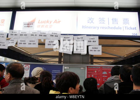 --FILE--i passeggeri in coda fino a l'itinerario ripianificare un contatore di Lucky aria a Kunming Changshui International Airport dopo i voli sono stati annullato Foto Stock