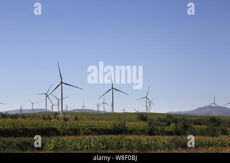 --FILE--turbine eoliche whirl per generare energia elettrica in corrispondenza di una fattoria eolica in Datong City, a nord della Cina di nella provincia di Shanxi, 24 agosto 2014. La Cina lo scorso anno Foto Stock