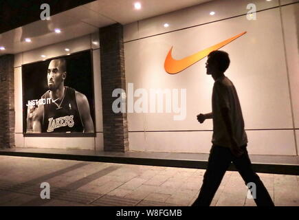 --FILE--A passeggiate a piedi passato un abbigliamento sportivo Nike Store in Cina a Shanghai, 16 settembre 2011. La Cina ha attirato 471 miliardi di yuan cinese ($73.62 bill Foto Stock