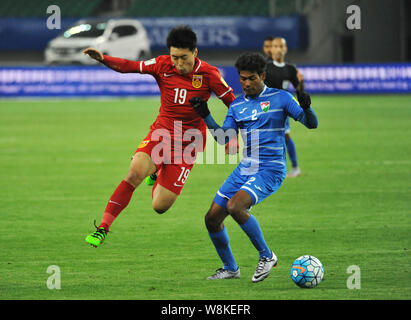 Jiang Ning della Cina, sinistra, sfide Mohamed Thasneem delle Maldive nel loro gruppo C match durante il secondo turno di qualificazioni asiatiche per il 2018 FIF Foto Stock