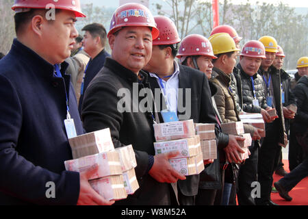 Cinese i lavoratori migranti mostrano fasci di stipendi presso il cantiere per la costruzione di un progetto immobiliare in Luoyang city, centrale cinese della provincia di Henan, 9 Foto Stock