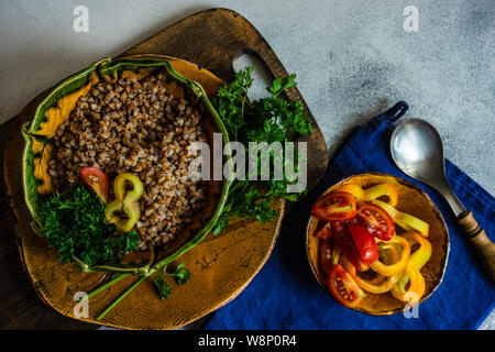 Dieta cheto concetto con bolliti di semi di grano saraceno e verdure in una ciotola rustico in pietra con sfondo copyspace Foto Stock