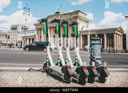 Berlino, Germania - Giugno, 2019: elettrica e scooter , escooter o e-scooter della società calce parcheggiato presso la Porta di Brandeburgo a Berlino Foto Stock