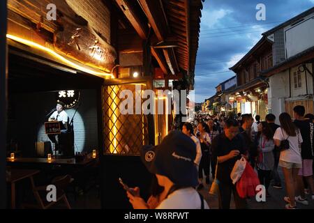 (190811) -- DALI, 11 Agosto, 2019 (Xinhua) -- una cantante esegue in un bar nella città vecchia di Dali, a sud-ovest della Cina di Provincia di Yunnan, il 10 agosto 2019. I turisti sono venuti qui per godere di incantevole vista notturna il cibo locale e attraente prestazioni durante le ore notturne. (Xinhua/Qin Qing) Foto Stock