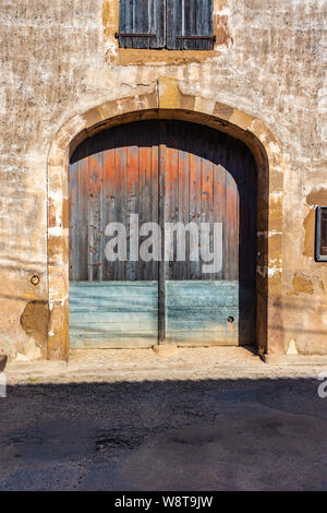 Doppie porte di gate su una vecchia fattoria di lavoro edificio Foto Stock