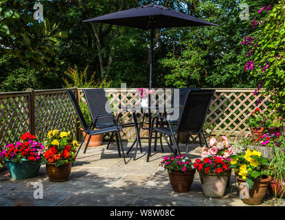 Un giardino inglese patio in estate. Foto Stock