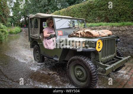 Lacock, Wiltshire, Regno Unito. 11 agosto 2019. Nonostante il meteo unseasonal centinaia di persone frequentano il veicolo militare e rievocazione Show a Lacock Foto Stock