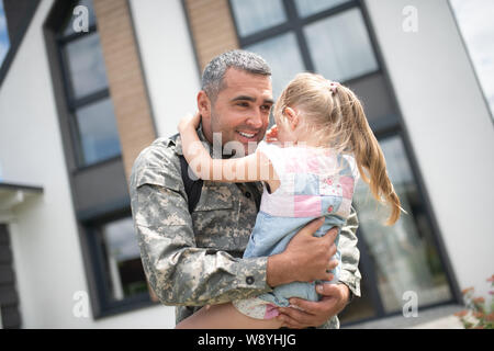 Carino ragazza piange dopo aver visto il Padre tornando a casa Foto Stock