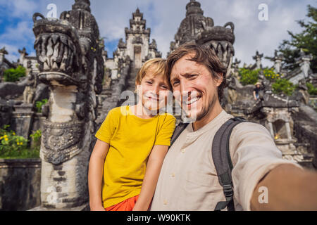 Papà e figlio turisti su sfondo di tre scale di pietra in bella Pura Luhur Lempuyang tempio. Portali Paduraksa marcatura entrata al centro Foto Stock