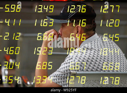 In questo multi-immagine di esposizione, un interessato investitore cinese guarda i prezzi delle azioni (verde per la caduta dei prezzi) in corrispondenza di un magazzino casa di brokeraggio in Huaibei Foto Stock