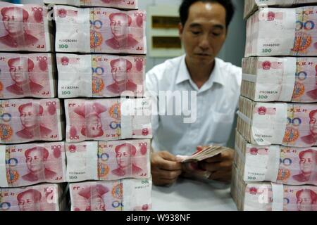 --FILE--un addetto cinese conta RMB (renminbi) presso una filiale di industriale e banca commerciale della Cina (ICBC) in Huaibei, est Chinas provincia di Anhui, 31 Foto Stock