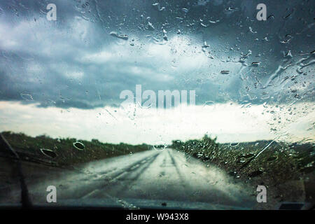 Driver vista di heavy rain attraverso la finestra auto Foto Stock