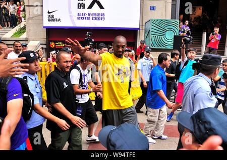 La superstar NBA Kobe Bryant onde ai tifosi in una strada pedonale sul suo modo di un evento per un incontro con i tifosi durante il suo tour in Cina nella città di Wuhan, porcellane centrale Foto Stock