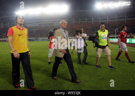 Marcello Lippi, seconda a sinistra, appena nominato head coach di Guangzhou Evergrande, cammina con il suo figlio Davide Lippi, sinistra, dopo Guangzhou Evergrande Foto Stock