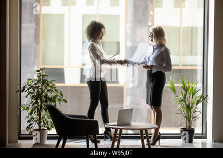 Coppia imprenditrice agitando la mano di African American business partner Foto Stock