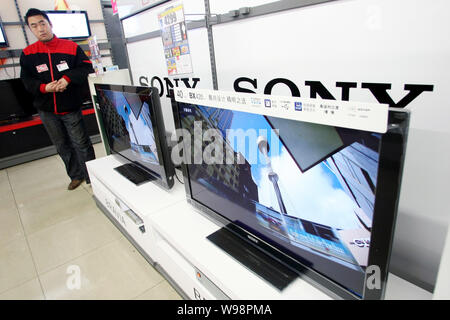 --FILE -- un venditore sorge accanto a televisori LCD Sony Bravia a un elettrodomestico store in Cina a Shanghai, 15 aprile 2011. Sony Corp. ha ricordato 1,6 m Foto Stock