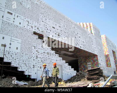 Lavoratori a piedi passato la Repubblica di Corea (Corea del Sud) Pavilion in costruzione nell'Expo di Shanghai, Cina, 19 marzo 2010. Foto Stock