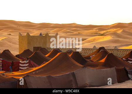 Dorf in der Wüste Marokkos. Beduinenzelte bei Sonnenuntergang a Marokko. Foto Stock