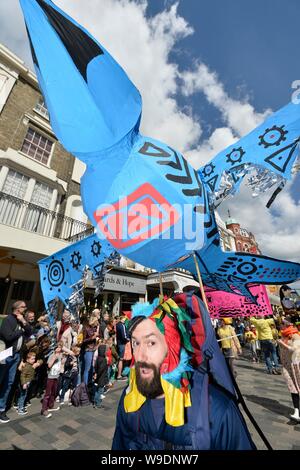 Marcare l'inizio del Brighton Festival 2019, i bambini sfilano tema di quest anno è di racconti popolari di tutto il mondo Foto Stock