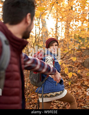 POV foto di un attraente caucasian escursionismo coppia attraverso il bosco in autunno in Canada Foto Stock