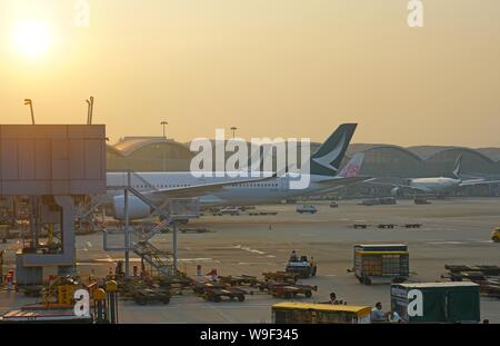 HONG KONG -18 LUG 2019- vista del tramonto su aeroplani da Cathay Pacific (CX) presso la trafficata Hong Kong International Airport (HKG), situato in Chek Lap Foto Stock