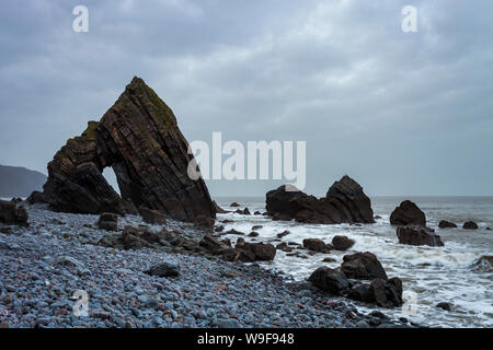 Blackchurch Rock è un punto di riferimento locale pietra naturale arco sulla North Devon costa. La marea è fuori così le rocce circostanti sono visibili. Foto Stock