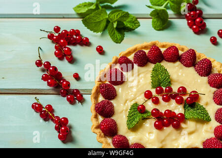 Ribes rosso torta con frutti di bosco freschi come dessert estivo su sfondo di legno. Foto Stock