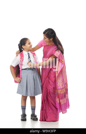 Donna che ottiene la figlia pronta per la scuola Foto Stock