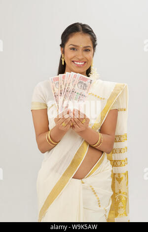 South Indian woman showing banknotes Stock Photo