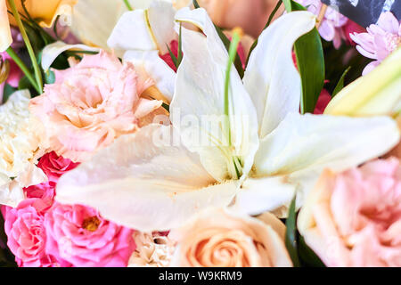 Bouquet di fiori è costituito da gigli, rose, astras. close up foto ritagliata. estate umore, meraviglioso aroma, composizione magica Foto Stock