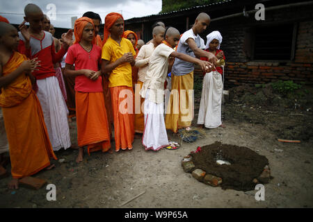 Kathmandu, Nepal. Il 15 agosto, 2019. Giovani nepalesi sacerdoti indù eseguire rituali durante Janai Purnima il filetto sacred festival nel Tempio Pashupathinath a Kathmandu, Nepal, giovedì 15 agosto, 2019. Si è creduto che la legatura del filetto sacred rid malattie della pelle. Credito: Skanda Gautam/ZUMA filo/Alamy Live News Foto Stock