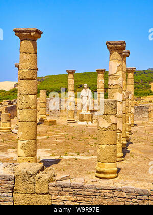 Resti della Basilica principale e la statua dell'Imperatore Traiano in Baelo Claudia sito archeologico. Tarifa, Cadice. Andalusia, Spagna. Foto Stock