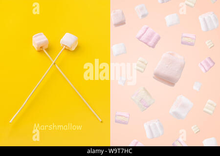 Layout creativo fatto di Bella bianca e rosa marshmallows e marshmallow su un bastone Foto Stock