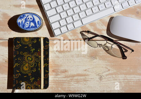 Desktop moderno, il computer wireless per la tastiera e il mouse con il notebook e la coppia di bicchieri. Piatto fotografia laici, con spazio di copia Foto Stock