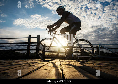 Ciclista a cavallo su Selkirk traliccio al tramonto - Victoria, Isola di Vancouver, British Columbia, Canada Foto Stock