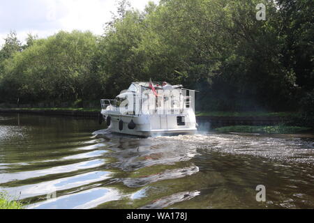 Imbarcazione da diporto che naviga lungo Aire e Calder Navigation, un canale nello Yorkshire occidentale di Knottingley in Gran Bretagna, Regno Unito Foto Stock