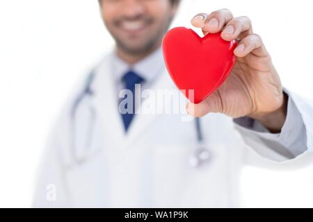 Medico azienda forma di cuore. Foto Stock