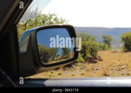 La riflessione di un paesaggio in un specchio auto Foto Stock
