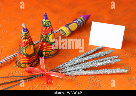 Fire crackers with a blank card isolated on orange background Stock Photo