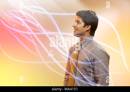 Uomo d'affari che guarda i flussi di luce e sorride Foto Stock